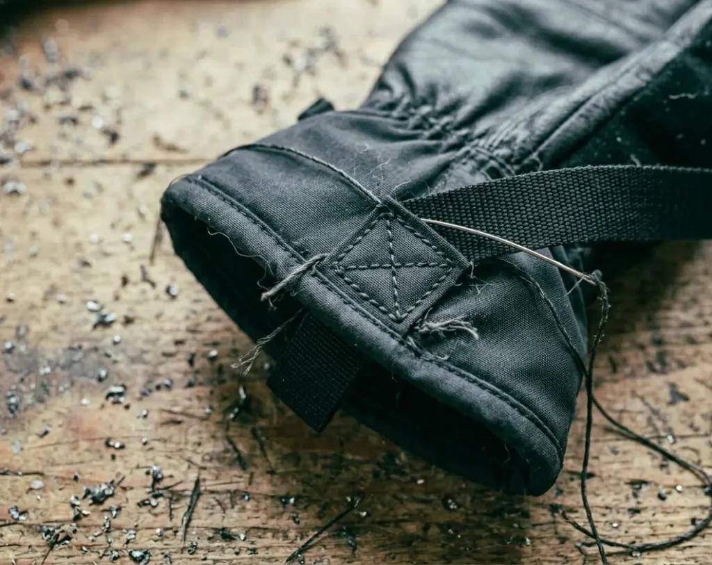 Sewing a box stitch with heavy-duty thread to securely replace a ski glove strap