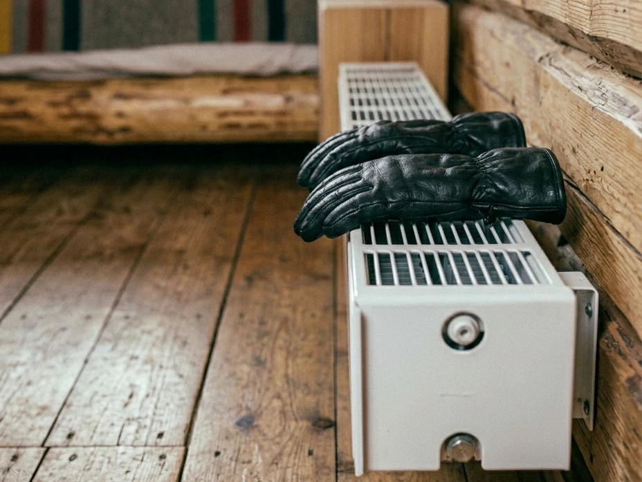 Ski gloves sitting directly on a hot radiator, which causes permanent insulation damage