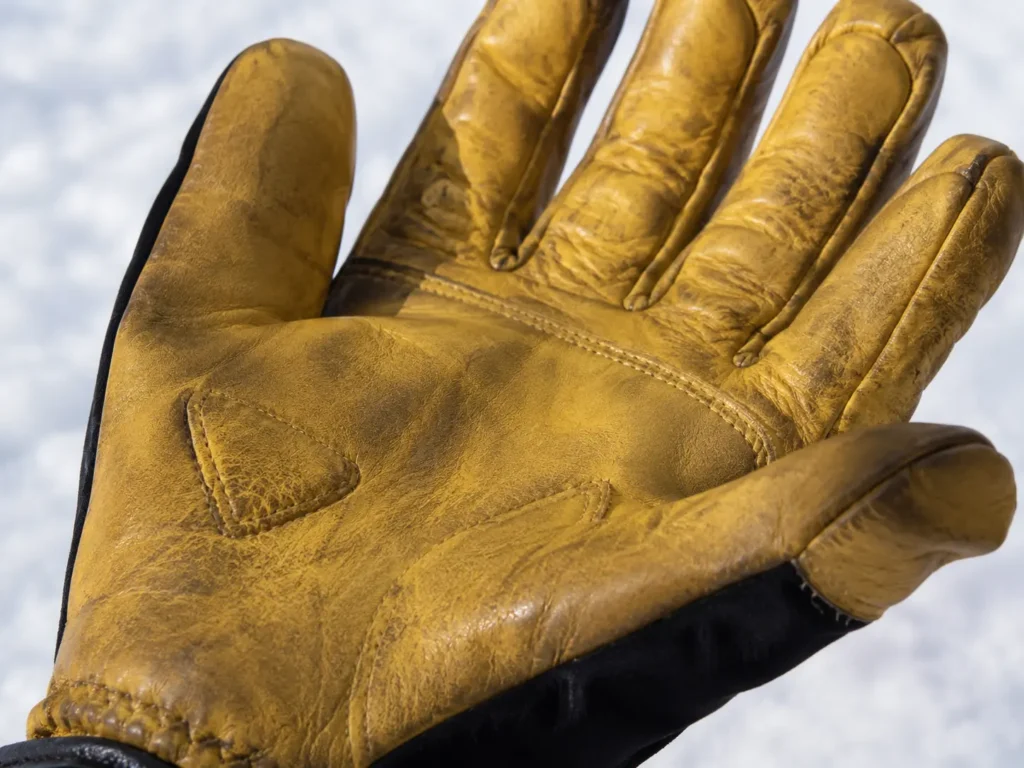 Worn leather glove texture close-up