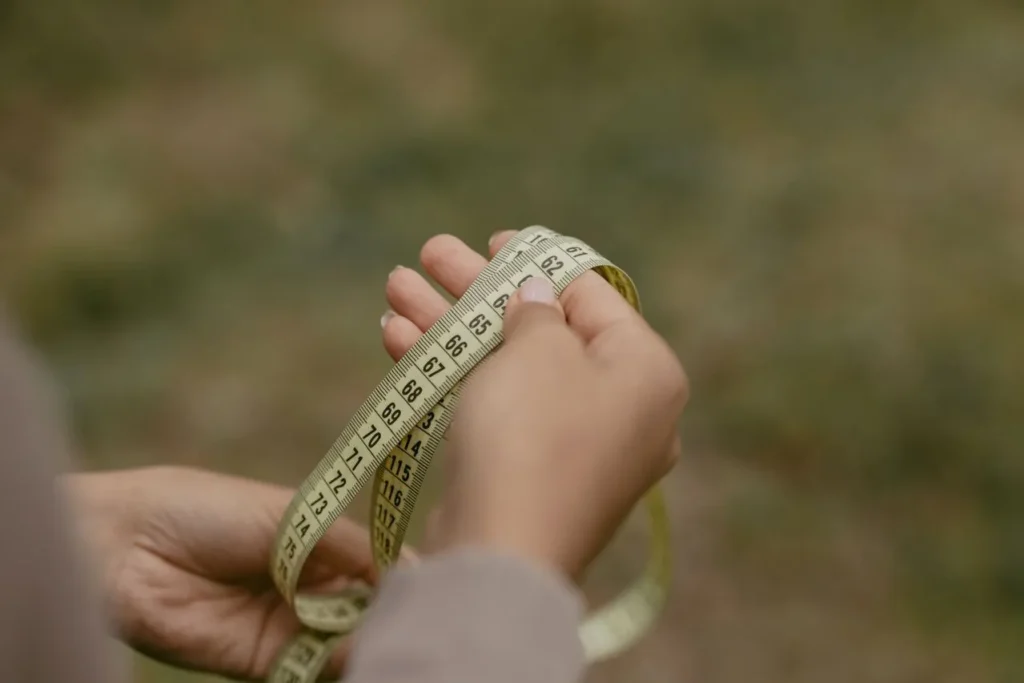 Measuring tape wrapped around a hand