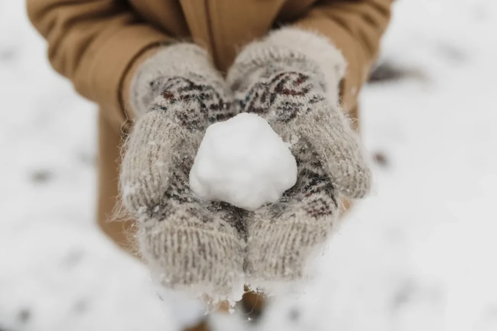 Close-up of insulated winter mitten in snow