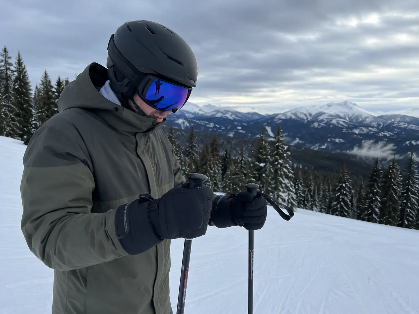 A skier holding ski poles on a winter day, highlighting why do ski gloves feel so bulky