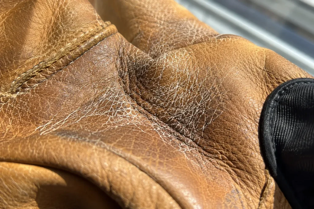 Salt deposit cracking on a leather palm demonstrating how to stop sweat from ruining ski gloves
