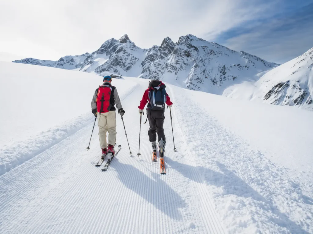 Skier skinning uphill generating body heat on a tour