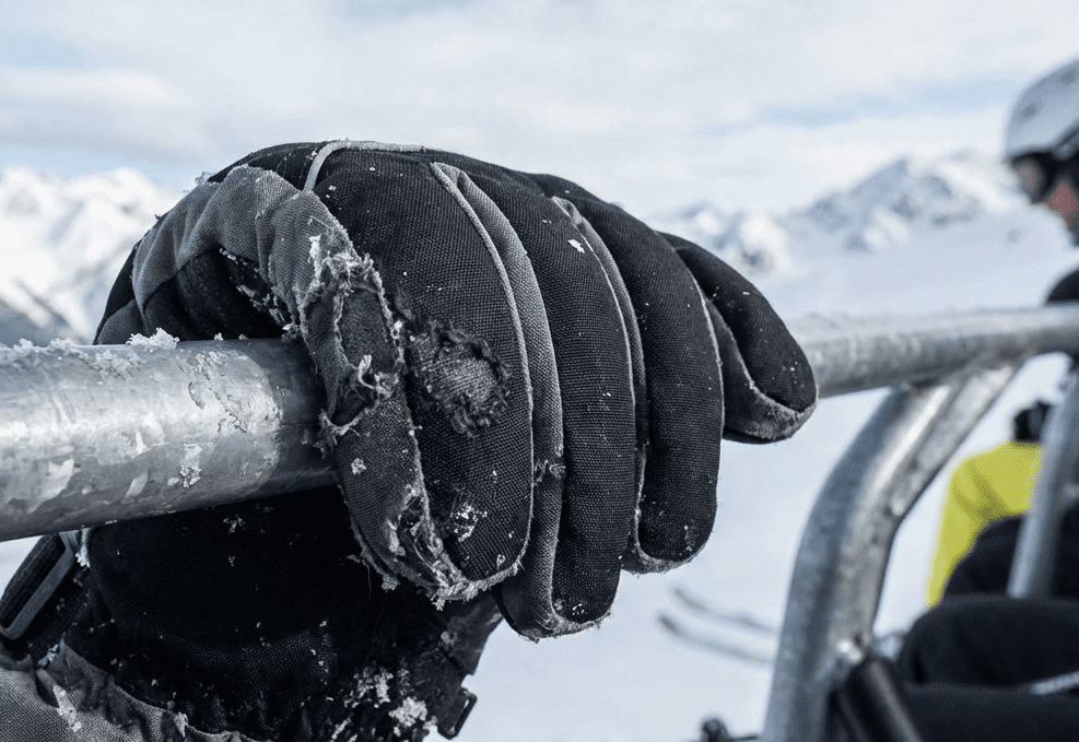 ski gloves rubbing against metal chairlift bar