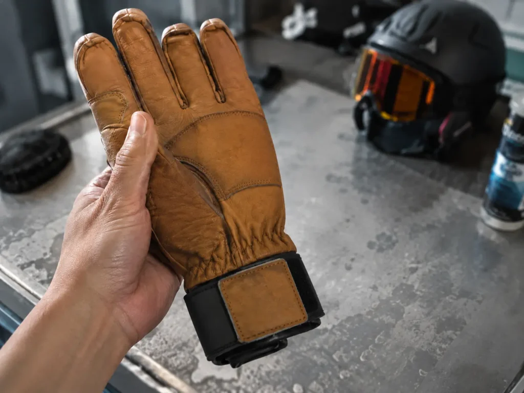 How to break in leather ski gloves — hand flexing a stiff new leather glove