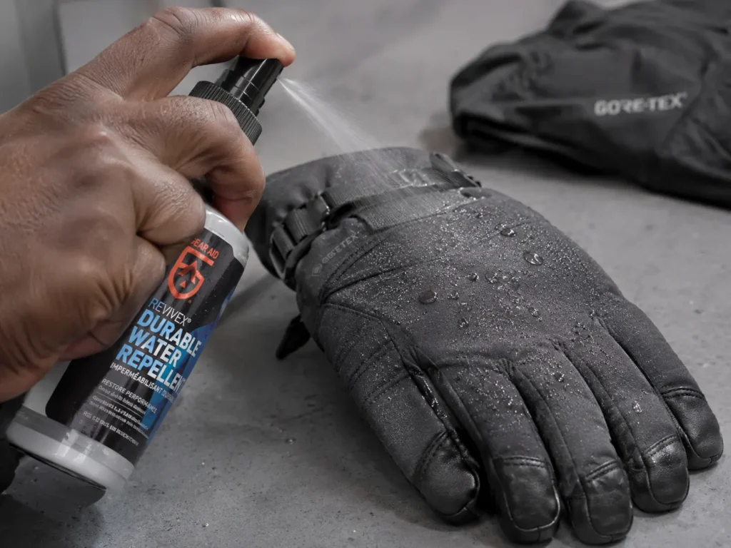 How to reproof ski gloves — spraying DWR waterproofing treatment on a glove shell