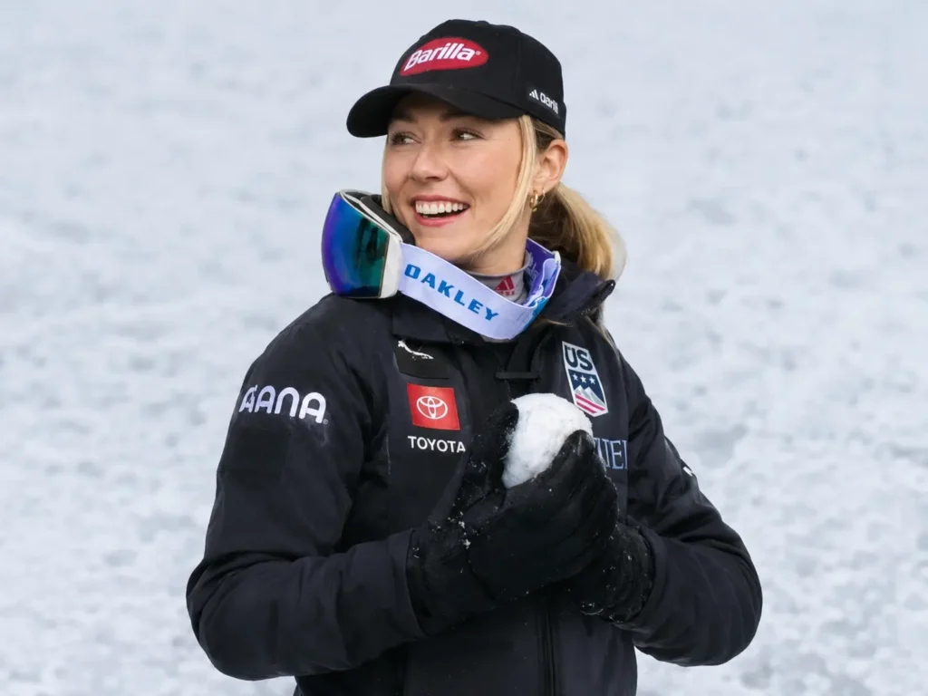 Skier packing a snowball to test glove performance