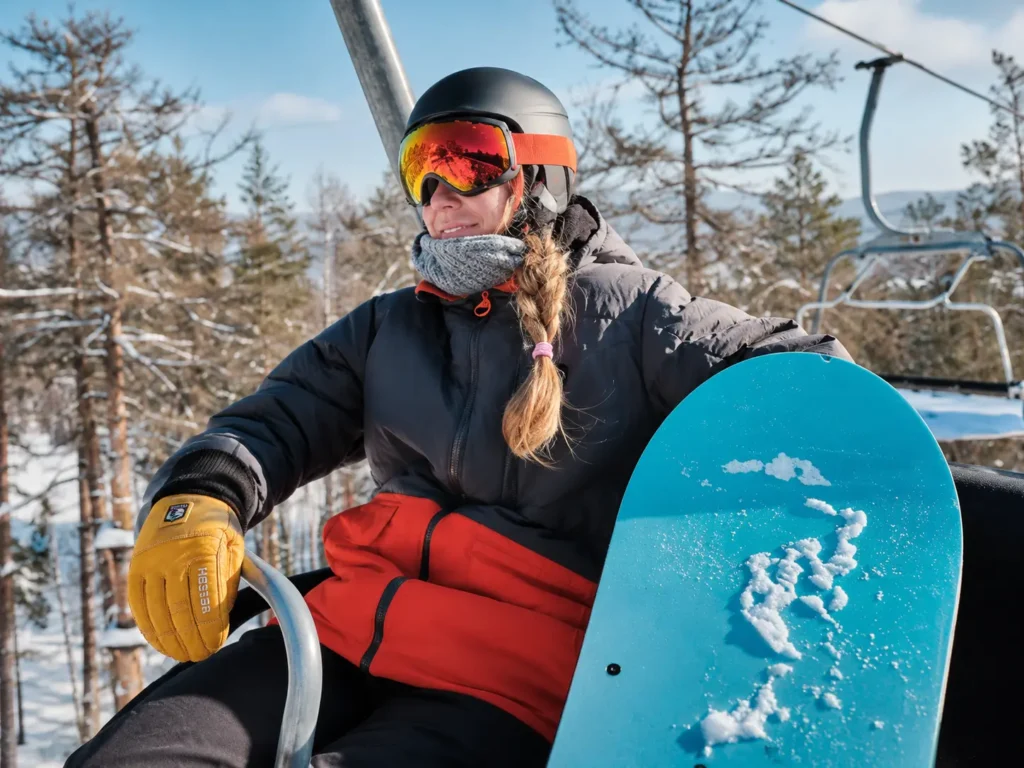 Skier pulling on gloves before a lift ride