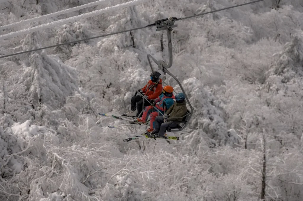 Skier in wet snow conditions on a chairlift