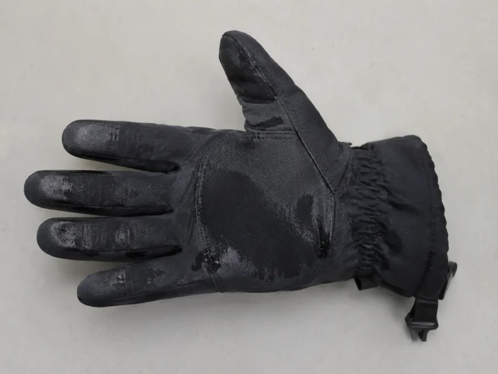Glove showing dark, saturated patches from water absorption