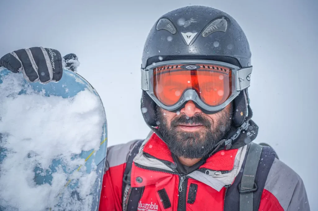 Ski instructor on the mountain wearing well-used gloves