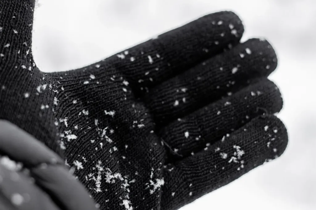 Worn glove palm showing abrasion from ice contact