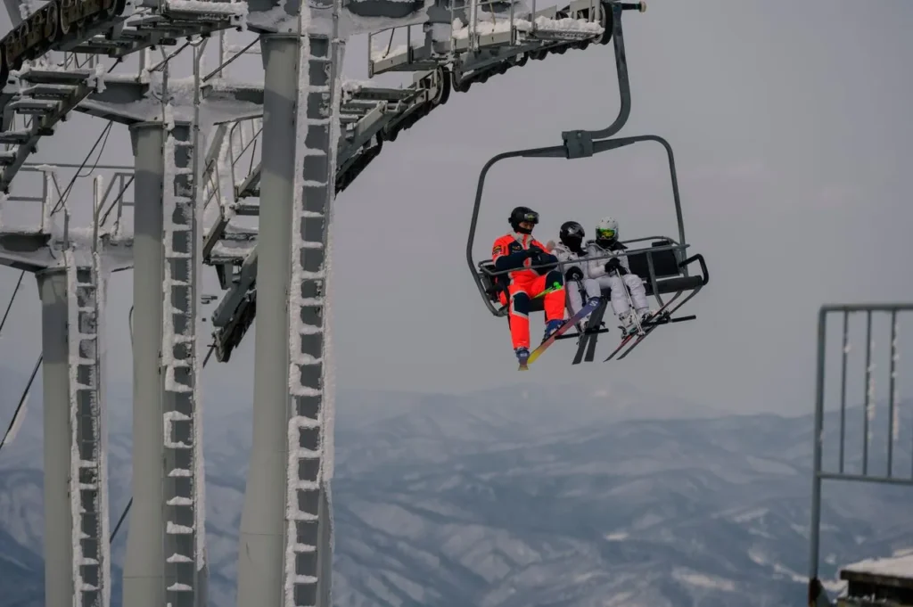 Skier on a chairlift in cold conditions