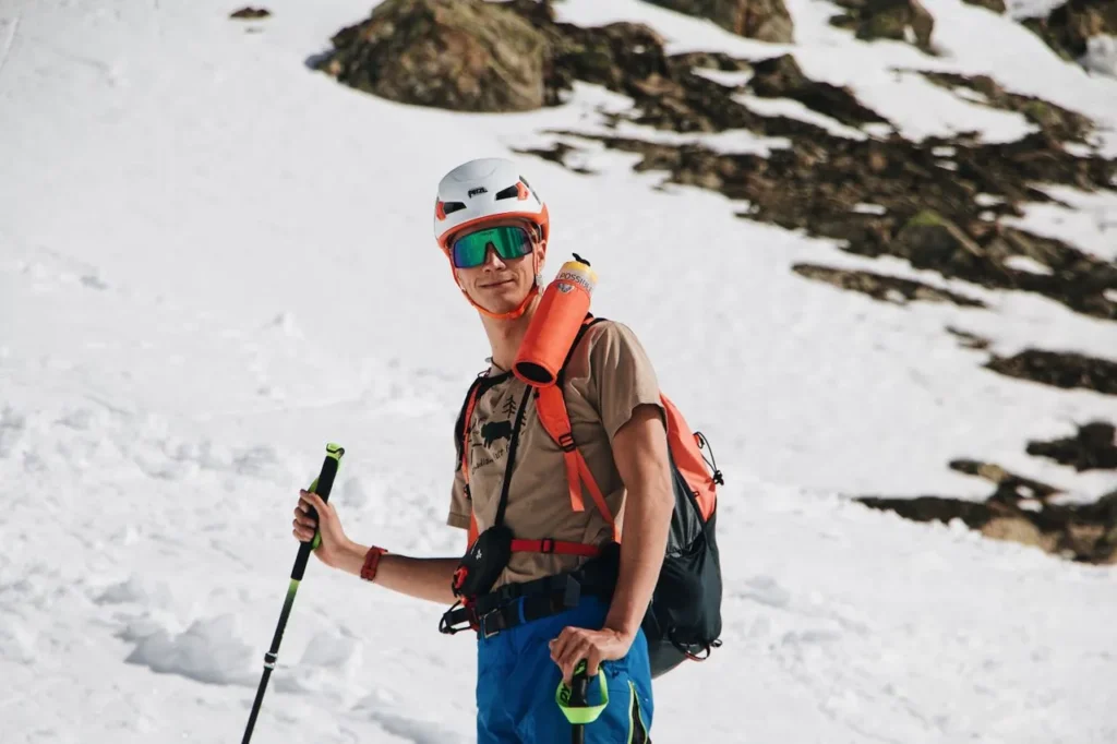 Skier gripping a ski pole on a groomed run