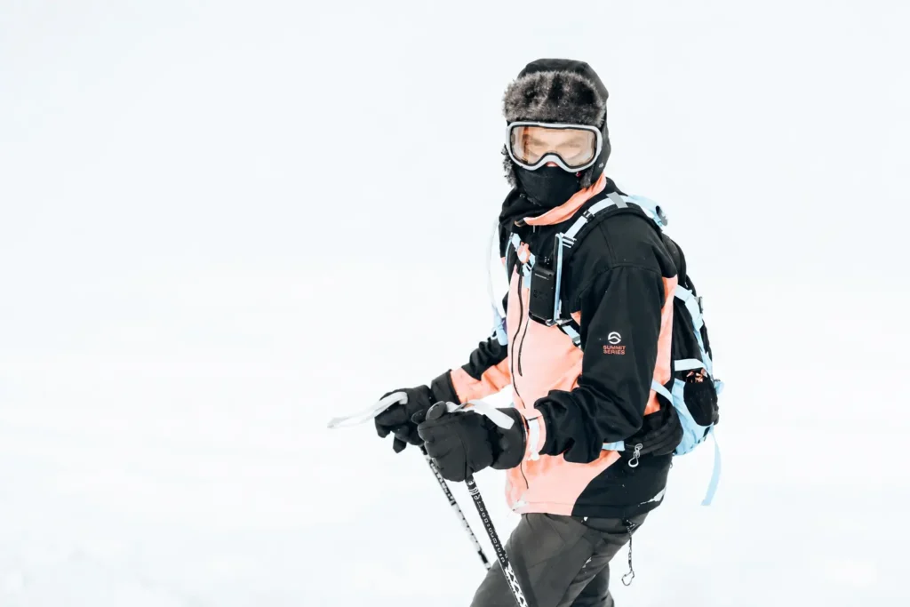 Best ski gloves for men 2026 — gloved hand gripping a ski pole on a groomed run