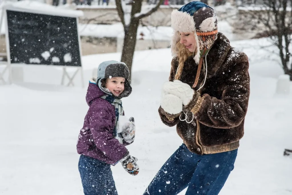 Child wearing waterproof winter gloves playing in snow