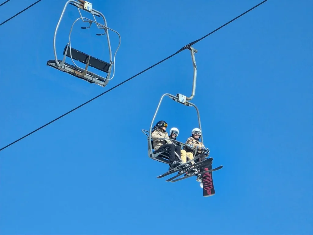 Female skier on a chairlift in winter conditions