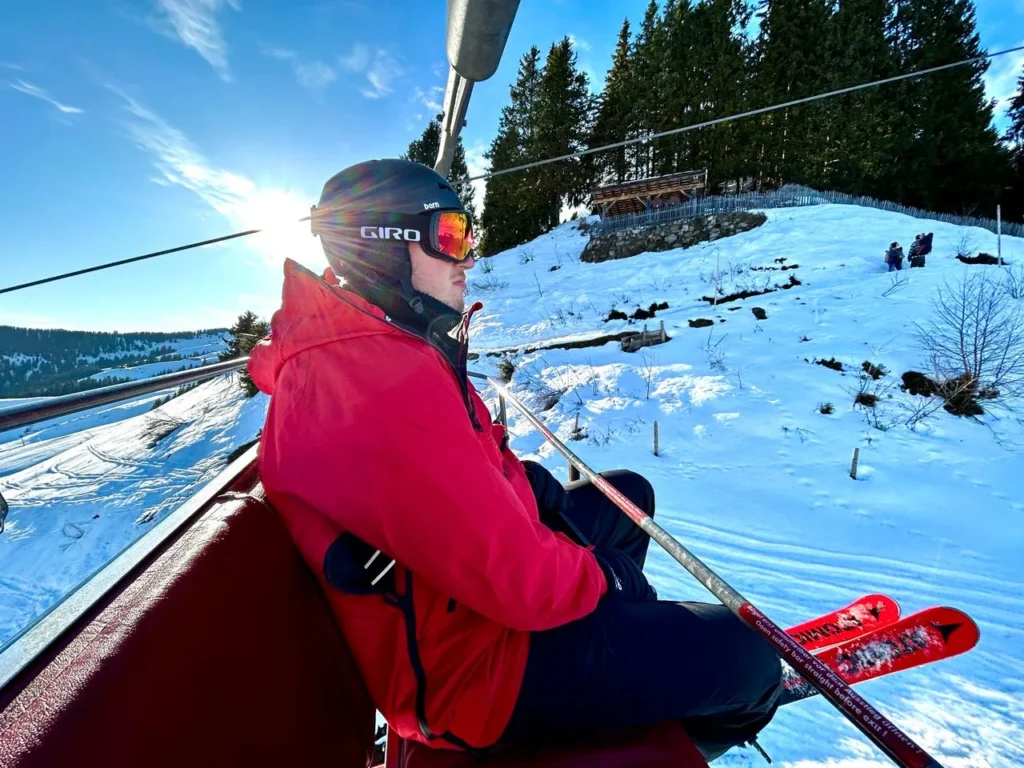 Skier on a chairlift in cold winter conditions