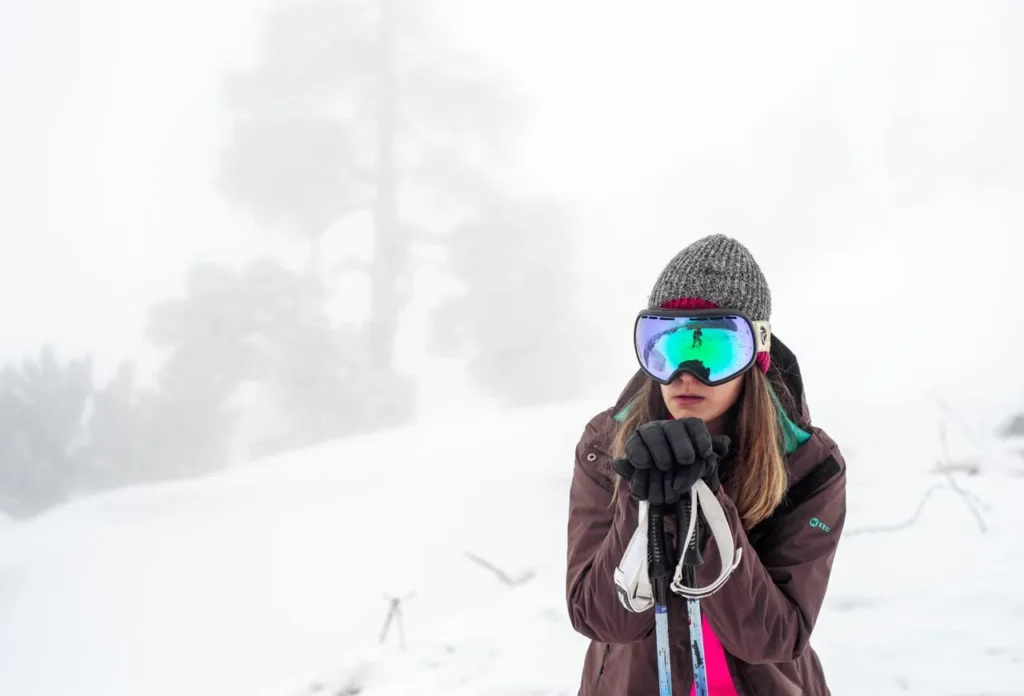 Woman skier wearing ski gloves in the snow
