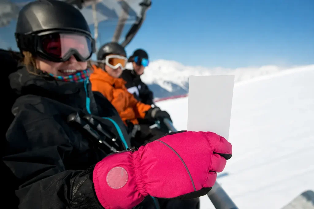 Best ski mittens of 2026 — insulated leather mitten gripping a chairlift bar in falling snow