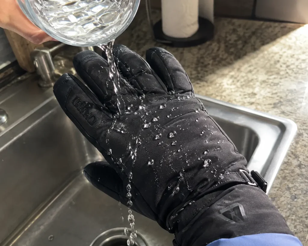 Testing the surface DWR of the best waterproof ski gloves with a water pour test