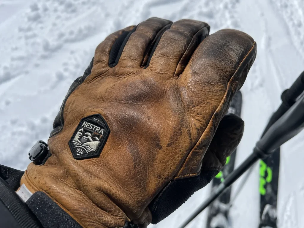 Close up of used leather ski gloves showing natural patina and wear after a long ski season