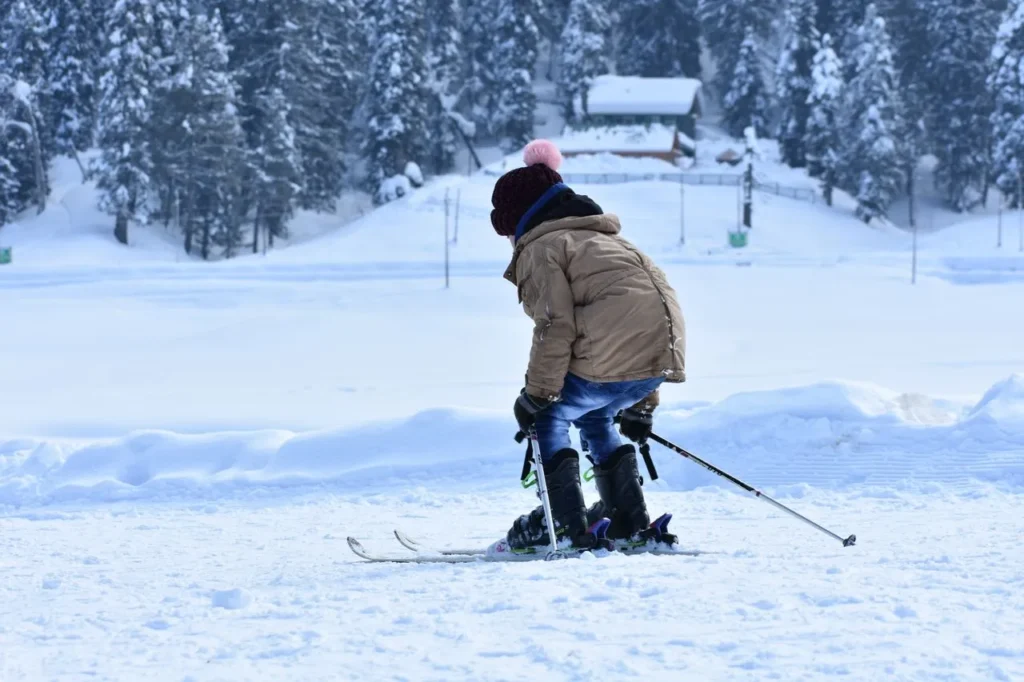 Beginner skier on a mild resort day wearing winter gloves
