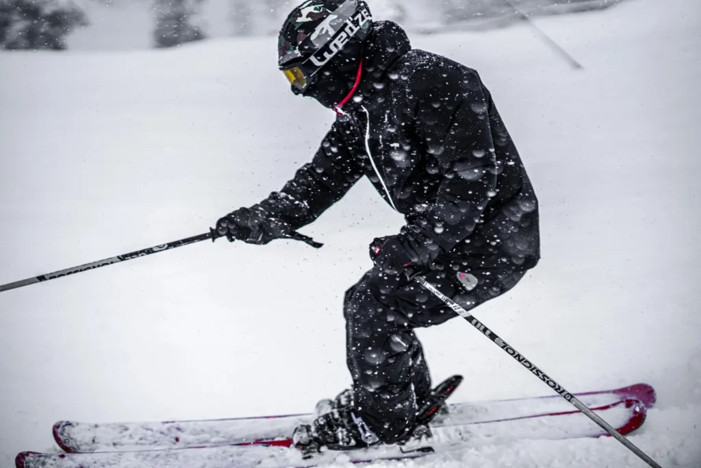 Skier's Gore-Tex gloved hand gripping a ski pole