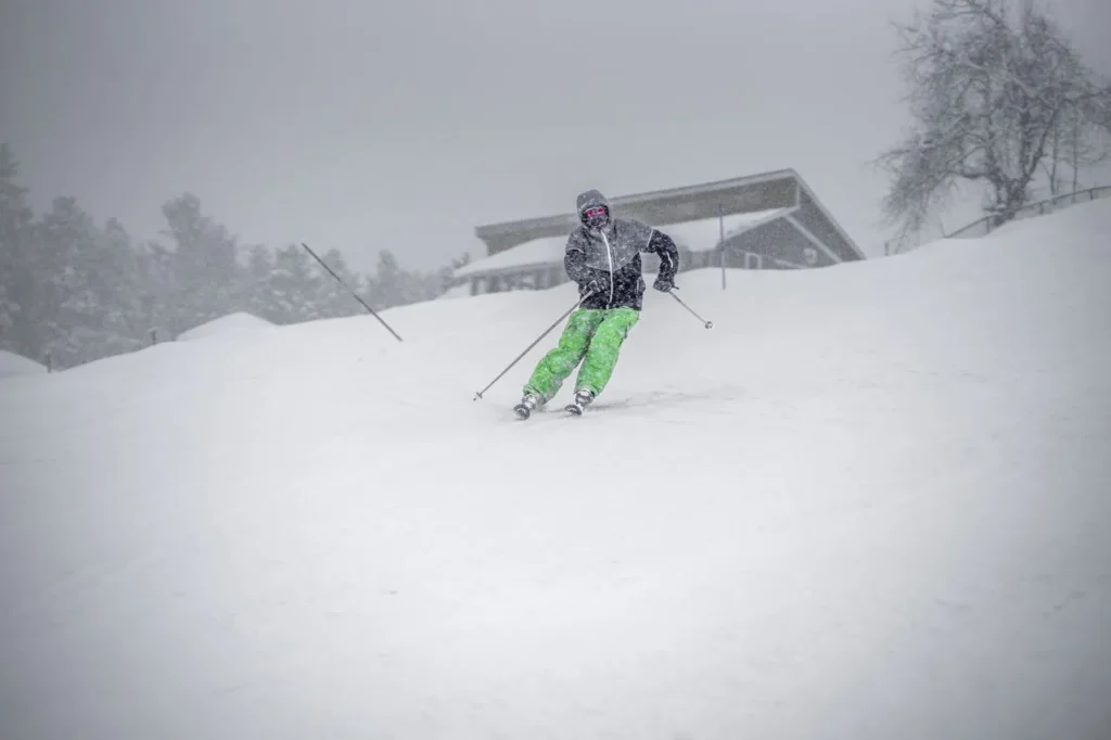 Skier in wet, heavy resort snow conditions