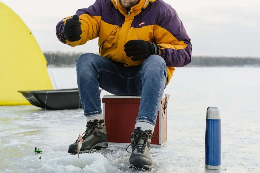 Ice fishing with gloves on a frozen lake — best gloves for ice fishing